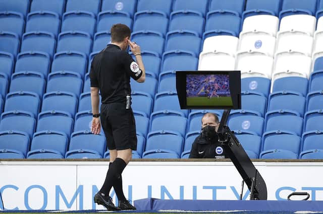 Referee Peter Bankes checks VAR for a red card which is given to John Lundstram of Sheffield United  during the Premier League match between Brighton & Hove Albion and Sheffield United at American Express Community Stadium on December 20, 2020 in Brighton  (Photo by John Sibley - Pool/Getty Images)