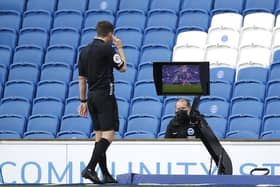 Referee Peter Bankes checks VAR for a red card which is given to John Lundstram of Sheffield United  during the Premier League match between Brighton & Hove Albion and Sheffield United at American Express Community Stadium on December 20, 2020 in Brighton  (Photo by John Sibley - Pool/Getty Images)
