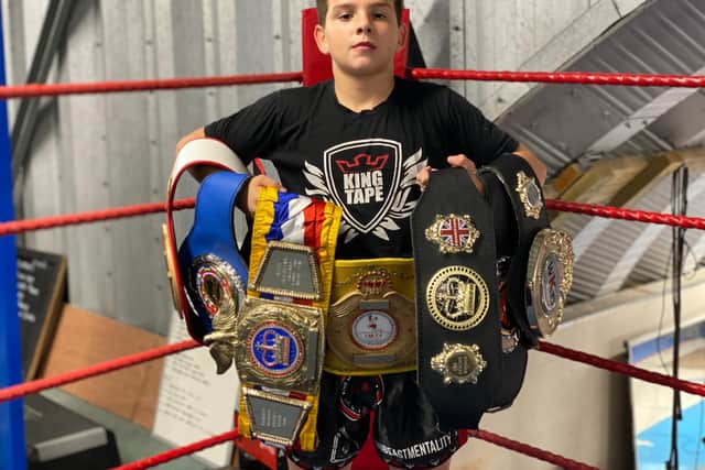 Tyler Hourihan with the world titles that he has won so far.