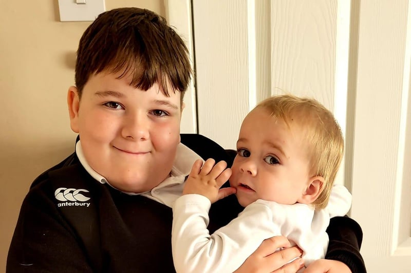 A cuddle for Jacob, who is starting Year 7, with little brother Roman.