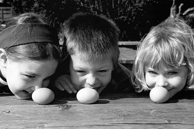 Taking part in the egg rolling competition at the Royal Oak pub, Tickhill, are, from left, Victoria Taylor, aged ten, Stephen Scothern, aged seven, and Jessica Pearce, aged six, April 13, 1998