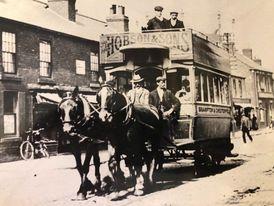 A horse drawn carriage passes through Chesterfield in 1900