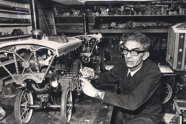 Albert Cooling, head caretaker at Westfield school, Mosborough with one of his models of a stem engine he has made April 1975