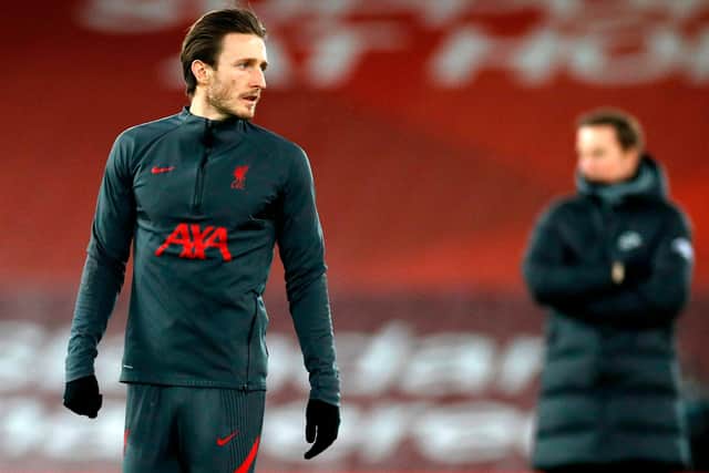 Liverpool's English defender Ben Davies (L) warms up ahead of the English Premier League football match between Liverpool and Brighton and Hove Albion at Anfield in Liverpool, north west England on February 3, 2021: PHIL NOBLE/POOL/AFP via Getty Images