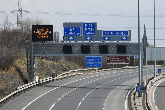 A sign above Glasgow's M8 read 'Avoid travel where possible'. Picture: John Devlin
