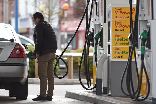 A man fills up his car from a petrol pump at a garage. Picture: Paul Ellis/AFP via Getty Images.