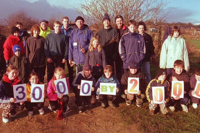Pictured in 1999 at Handsworth Grange school, Sheffield, where pupils, parents, teachers and local residents were out to plant the  Millennium hedge containing 1000 trees.  The sign shows that the group wants to plant 3000 trees  by the year 2000.