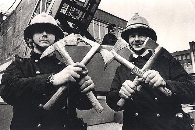 Fireman Nigel Kind, left and Leading Fireman David Goldthorp, with belt axes, which they will disacard. A set of four are to be carried in each appliance;and the restb sold off at 50 pence each. January 1977