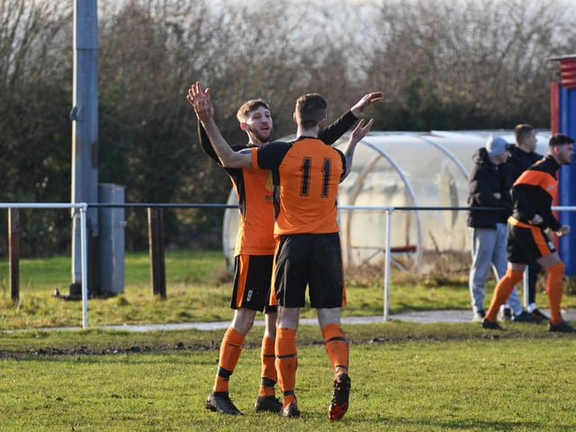 Shaun Mundy celebrates his equalising goal with a teammate.