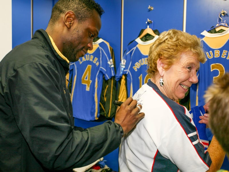 Full-back Lauren signing a fan's shirt. Picture: Habibur Rahman