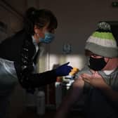A man receives a dose of the Pfizer Covid-19 vaccine in a vaccination clinic set up at St Columba's Church in Sheffield