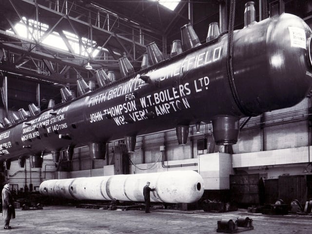 A giant drum is suspended in the crane during loading operations at the Atlas Works of Firth Brown Limited, Sheffield. Picture Firth Brown Ltd.
