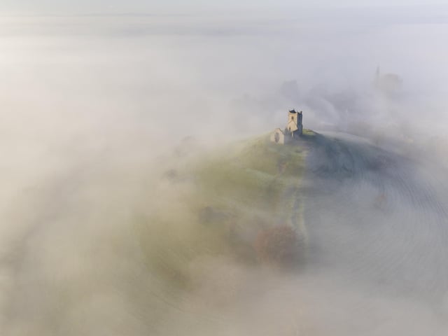 Winner - Historic England - Adam Burton - St Michaels Church, Burrow Mump, Somerset.
Skydivers over the Great Pyramids of Giza and a Welsh farmhouse are just some of the astonishing pictures from the 2020 Historic Photographer of the Year Awards. The awards called on photographers to capture “history all around usâ€, in the form of historical places and cultural sites around the world. Astonishing images of civilisation’s most iconic landmarks, including the Taj Mahal, Pompeii and the Palace of Versailles are just some of the historical sites featured. But the Overall Winner out of thousands of entries in the worldwide competition was awarded to Michael Marsh, for his sombre picture of Brighton Palace Pier, captioned “standing in the full force of weather and timeâ€.