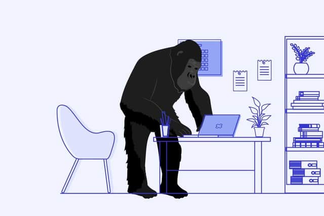 A gorilla stood over a desk, illustrating different desk postures.
