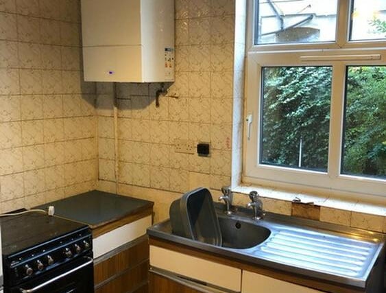 The fitted kitchen includes cupboards, preparation surface, stainless steel sink and drainer, splashback tiling, cooker point, plumbing for washing machine, wall mounted Worcester combination boiler and central heating radiator.