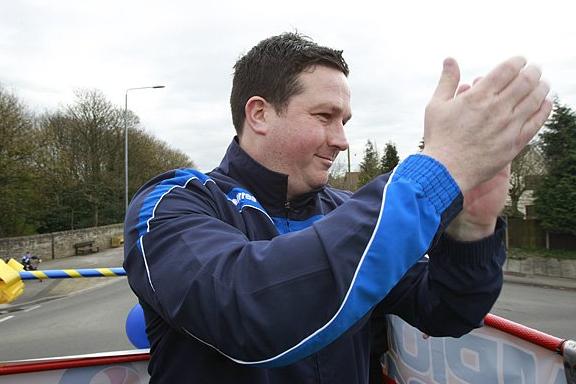 Paul Cox salutes the fans who turned out to cheer the Stags on their victory bus parade.
