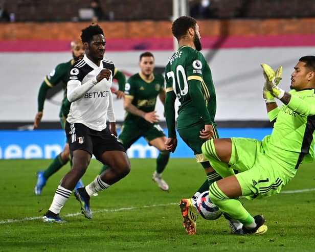 Jayden Bogle, of Sheffield United , is clattered by Fulham 'keeper Alphonse Areola - but a penalty was not given (Photo by Ben Stansall - Pool/Getty Images)