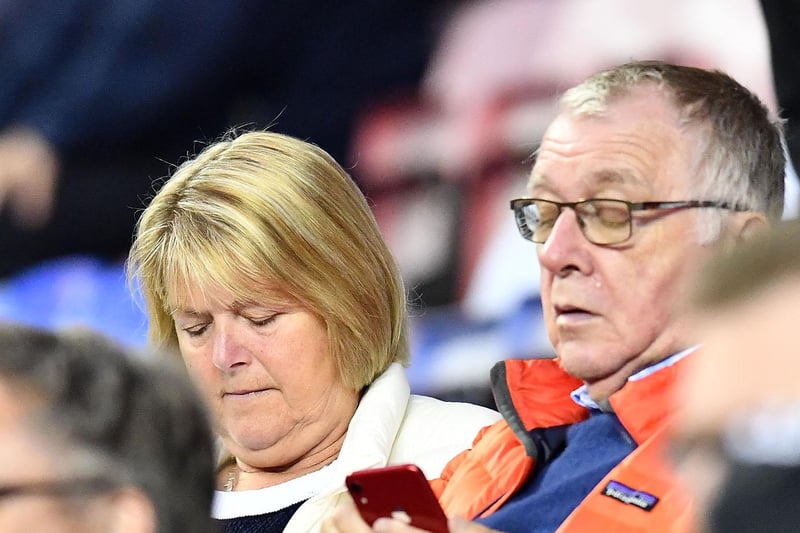 Sunderland fans check their phones during the Wigan clash.