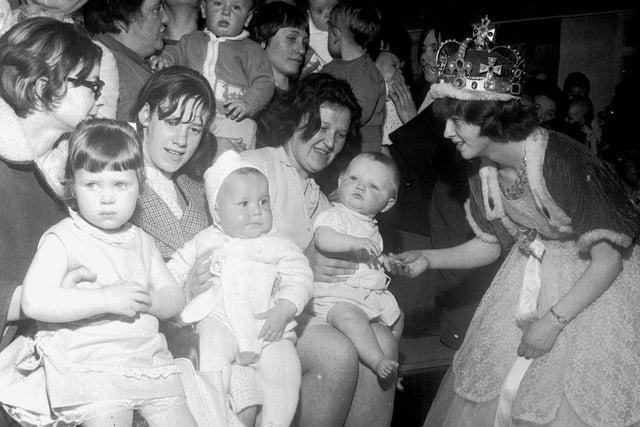 The Fair Queen judges the Bonnie Babies competition at the May Fair in Pilton in May 1966.