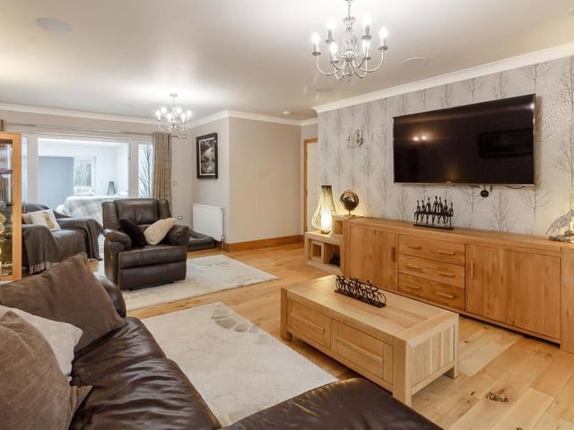 The largest room in the house is this bright and airy lounge, which sits at the end of a long entrance hallway. There are two radiators, a solid oak floor, coving to the ceiling, four wall-light points and two ceiling-light points.
