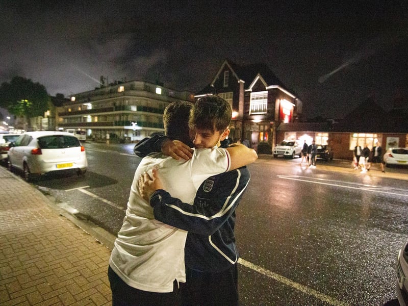 Ben Elliot and Jimmy Gladman console each other outside the Green Posts, Portsmouth. Picture: Habibur Rahman
