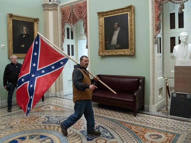 Supporters of US President Donald Trump protest in the US Capitol Rotunda on January 6, 2021, in Washington, DC. - Demonstrators breeched security and entered the Capitol as Congress debated the a 2020 presidential election Electoral Vote Certification. (Photo by SAUL LOEB / AFP)