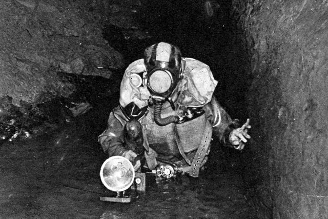 Mr J Clark a member of University of Sheffield Mountaineer Club (Pot Hole Section) exploring Peak Cavern at Castleton, 1972. Picture Sheffield Ref No: s29315