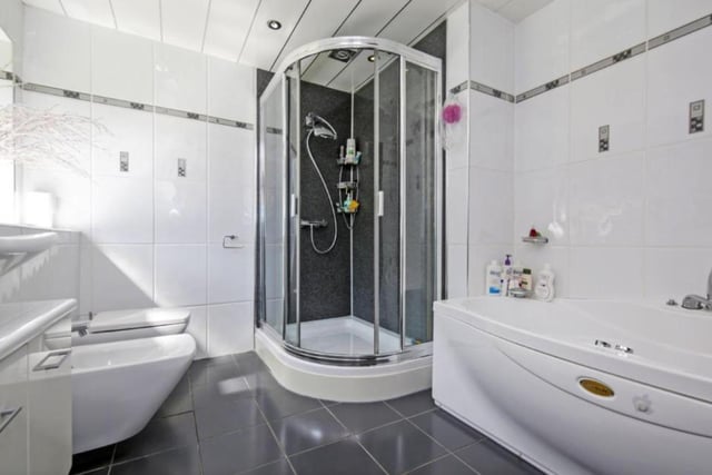 The house has a total of five bathrooms, with the large family bathroom offering a shower and sinking feature bath tub.