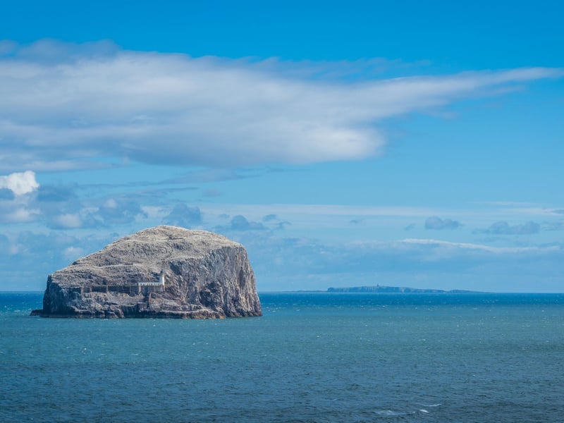 Rising out of the sea millions of years ago, Bass Rock is a volcanic plug which has been named "one of the wildlife wonders of the world" by David Attenborough. Found to the north east of North Berwick, its huge colony of 150,000 gannets makes it a Site of Special Scientific Interest. Besides the wildlife there is a lighthouse, old monastery, and ruins of a castle which was once a notorious gaol for religious and political prisoners. This remarkable isle has inspired writers including Robert Louis Stevenson.