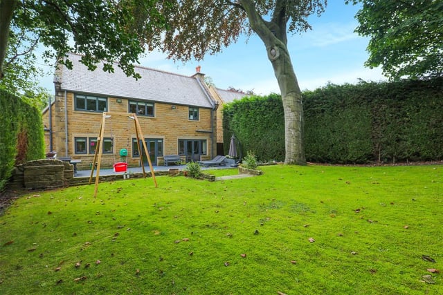 To the side and rear are generous landscaped gardens, offering security and privacy for families with children.