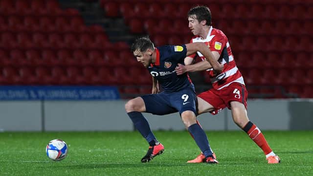 Tom Anderson tussles with Sunderland's Charlie Wyke. Picture: Andrew Roe/AHPIX