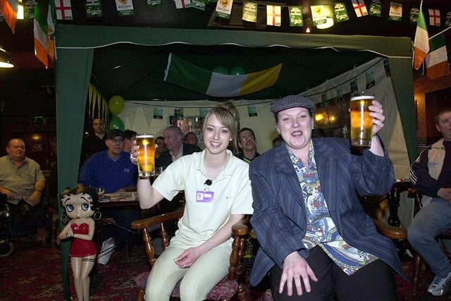 Bar staff, left, Angela Ansell and Laura Bunting watch the races at the Racing Club night with locals in the tent at The Sherwood pub, Birley Moor Road, Sheffield, March 2004