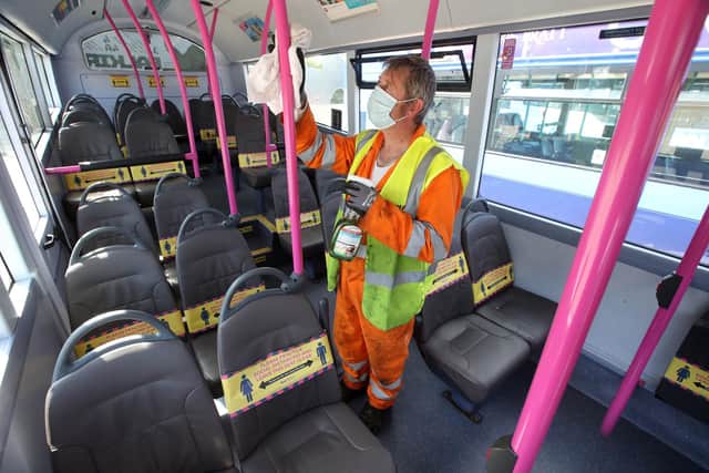 A First Bus cleaner prepares a bus ahead of the vehicle returning to service (photo: Andrew Milligan/PA Wire).