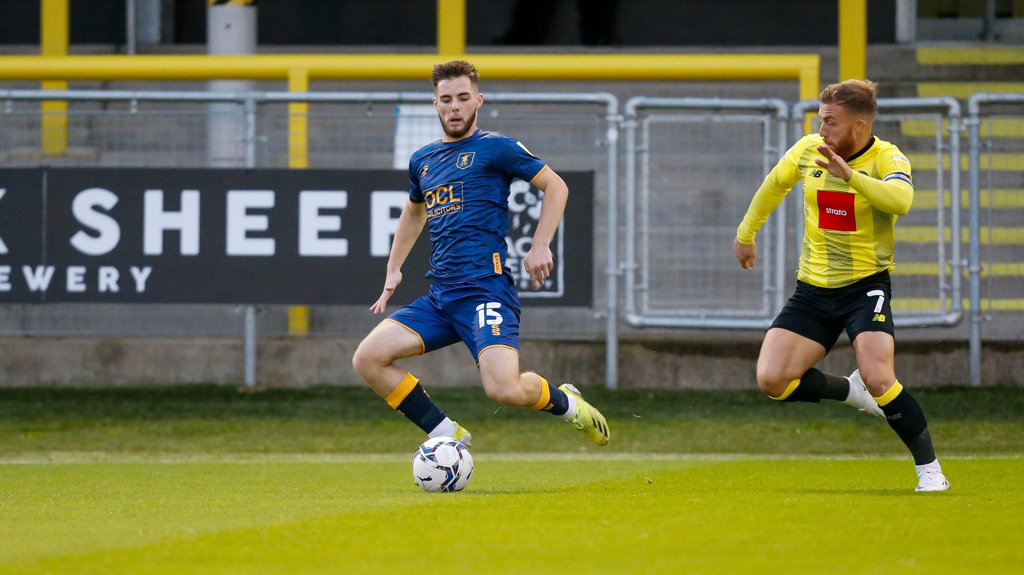 Ryan Burke controls the ball under the watchful eye of George Thomson.