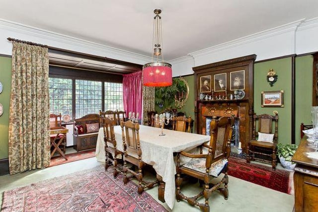 The formal dining room has a large glass box bay window, oak window panelling, dado rail and cornice