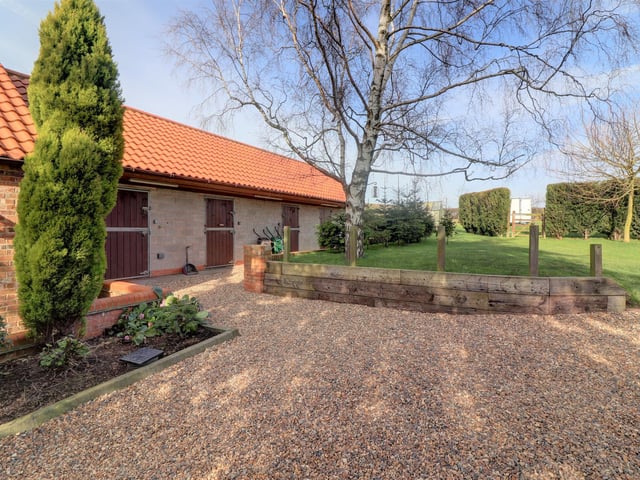 Behind the garage are four 12ft x 12ft stables, one of which is a tack room which benefits from power and lighting, has an insulated floor and ceiling, sink and WC facilities, with outside tap and light.