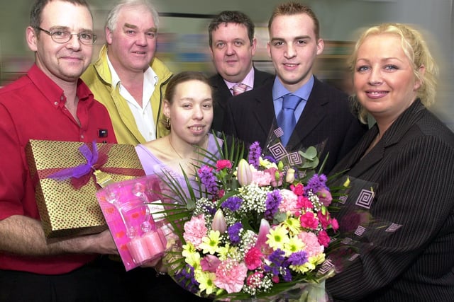 Valentine's competition winners Dawn Seymour, aged 18, of Dunscroft, and Andrew Oliver, aged 19, of Wheatley Hills, are pictured receiving their prizes from, (left to right) Woolworths assistant general store manager James Bower, Busy Lizzie's Terry Ward and Frankie and Benny's manager Gary Skelhorne. Looking on at the presentation which took place at The Star's Sunny Bar offices in 2004, is Star classified supervisor Karren Wake.