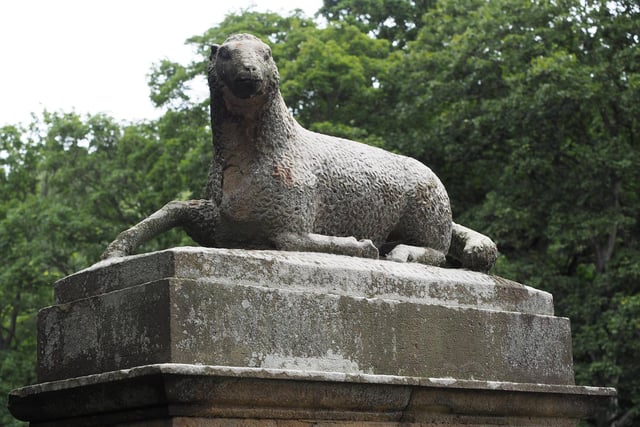 A carved sheep sits on a pillar on the Lamb Bridge.