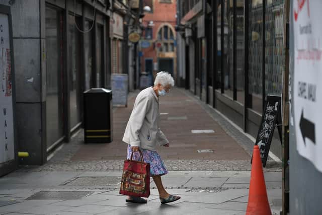 A shopper wears a face mask in the city centre of Sheffield (Photo by OLI SCARFF/AFP via Getty Images)