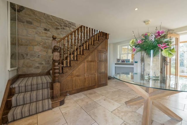 The description adds: "The main large reception hallway offers a first glimpse of this impression residence and provides access via an oak staircase to the first floor."