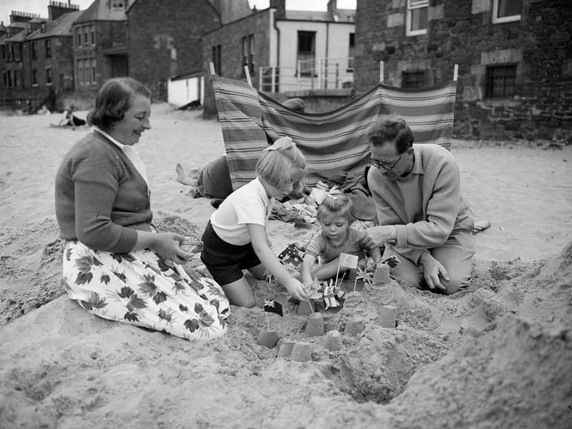 A family of holidaymakers building sandcastles at North Berwick in 1959.