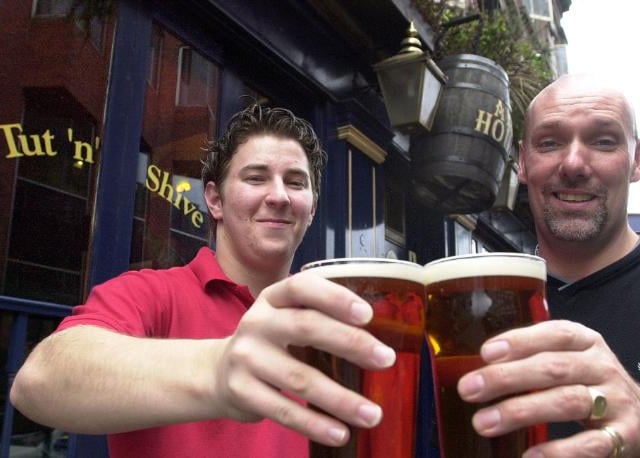 Tut 'n' Shive was voted the CAMRA's pub of the season for autumn 2001. Nick Coster and Andrew Butler here celebrating the award with a pint.