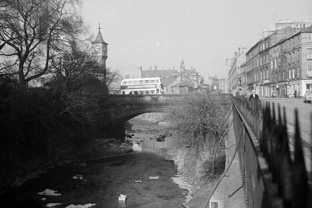 A bus drives over the Water of Leith in February 1962.