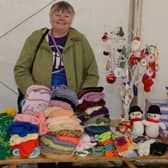 Janet Blackburn on one of her past Weston Park Cancer Charity stalls at a Percy Pud running event in Sheffield - she knits the official woolly hats for running group Steel City Striders