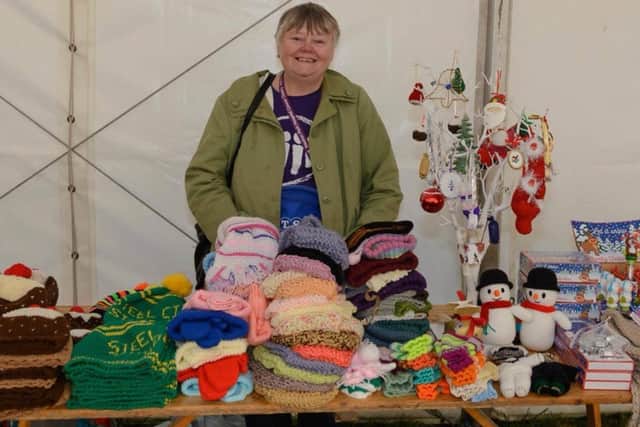 Janet Blackburn on one of her past Weston Park Cancer Charity stalls at a Percy Pud running event in Sheffield - she knits the official woolly hats for running group Steel City Striders