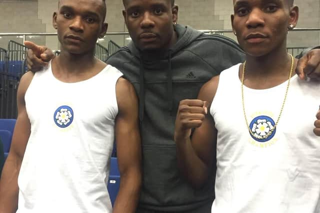 Levi Kinsiona (left) pictured in 2017 with his boxing brothers Christian (centre) and Dan.
