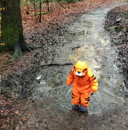 Foster child exploring a muddy path in Ecclesall Woods