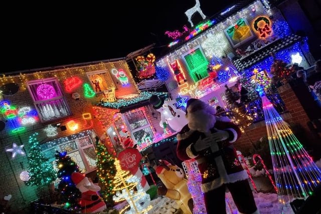 Andrew Green as Father Christmas in front of the amazing Christmas lights display on Lyons Street in Pitsmoor, Sheffield, created to raise money for The Sick Children's Trust