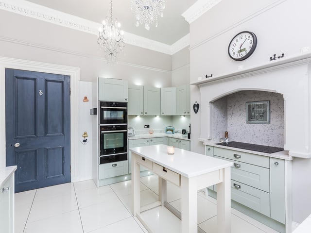 Built in Neff appliances comprising two ovens, five ring electric hob with extractor fan over, fridge freezer and dish washer.