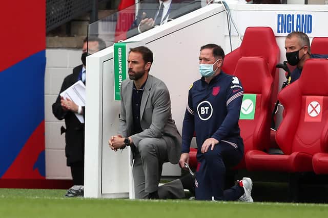 England's manager Gareth Southgate (L) and  Steve Holland, Assistant Coach of England (R) 'take a knee' ahead of the international friendly football match between England and Romania at the Riverside Stadium in Middlesbrough (Photo by SCOTT HEPPELL/POOL/AFP via Getty Images)
